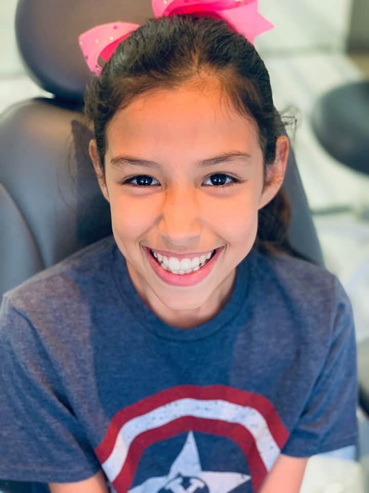 First time with Invisalign clear aligners in her mouth.