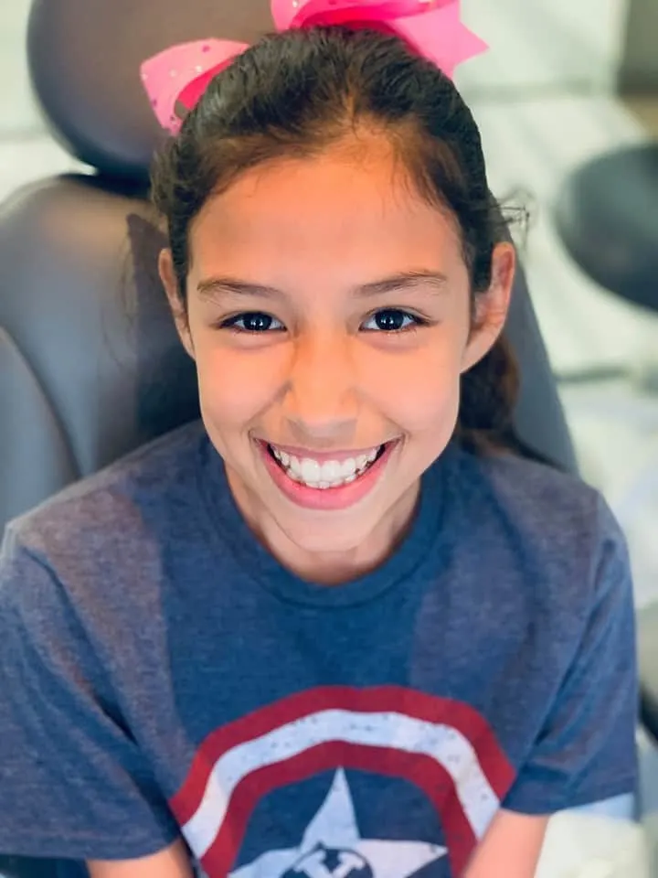 First time with Invisalign clear aligners in her mouth.