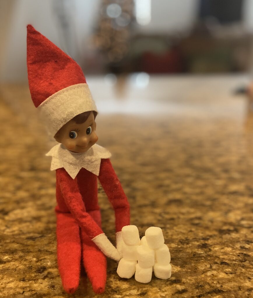 Elf on the shelf making a snow fort